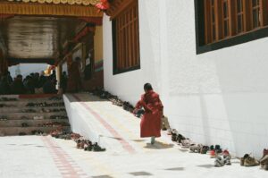 Film photo of a young monkin Ladakh on his way inside the prayer hall