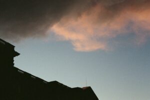 Film photo of a mountain sunset with pink clouds and mountain silhouettes