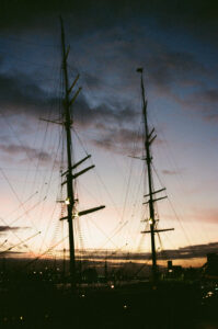 Sunset at a harbor with the silhouette of a ship