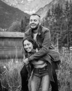 Black-and-white motion blur photo of a young couple during a piggyback ride