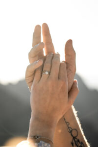 Close-up of hands with an engagement ring in golden light
