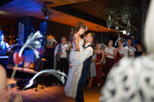 The groom lifts his bride during the wedding dance