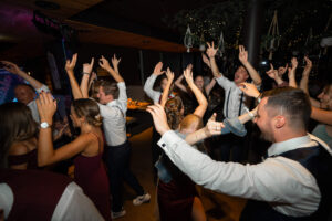 Joyful dance floor atmosphere with hands raised in the air