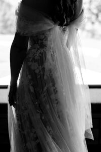 Black-and-white detail shot of the wedding dress from behind