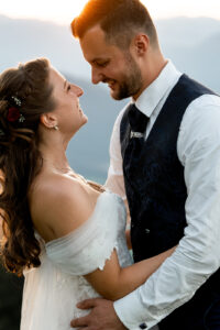 Close-up of the wedding couple embracing at sunset