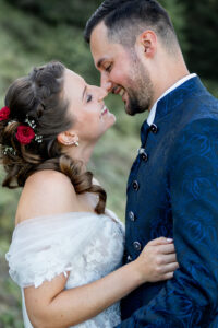Close-up of the bride and groom leaning their heads together, almost kissing