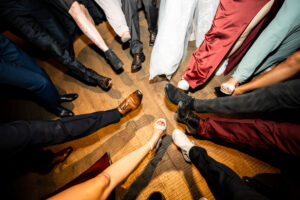 Close-up of guests’ shoes arranged in a circle on the dance floor