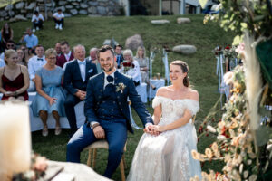 Wedding couple holding hands and laughing during the ceremony