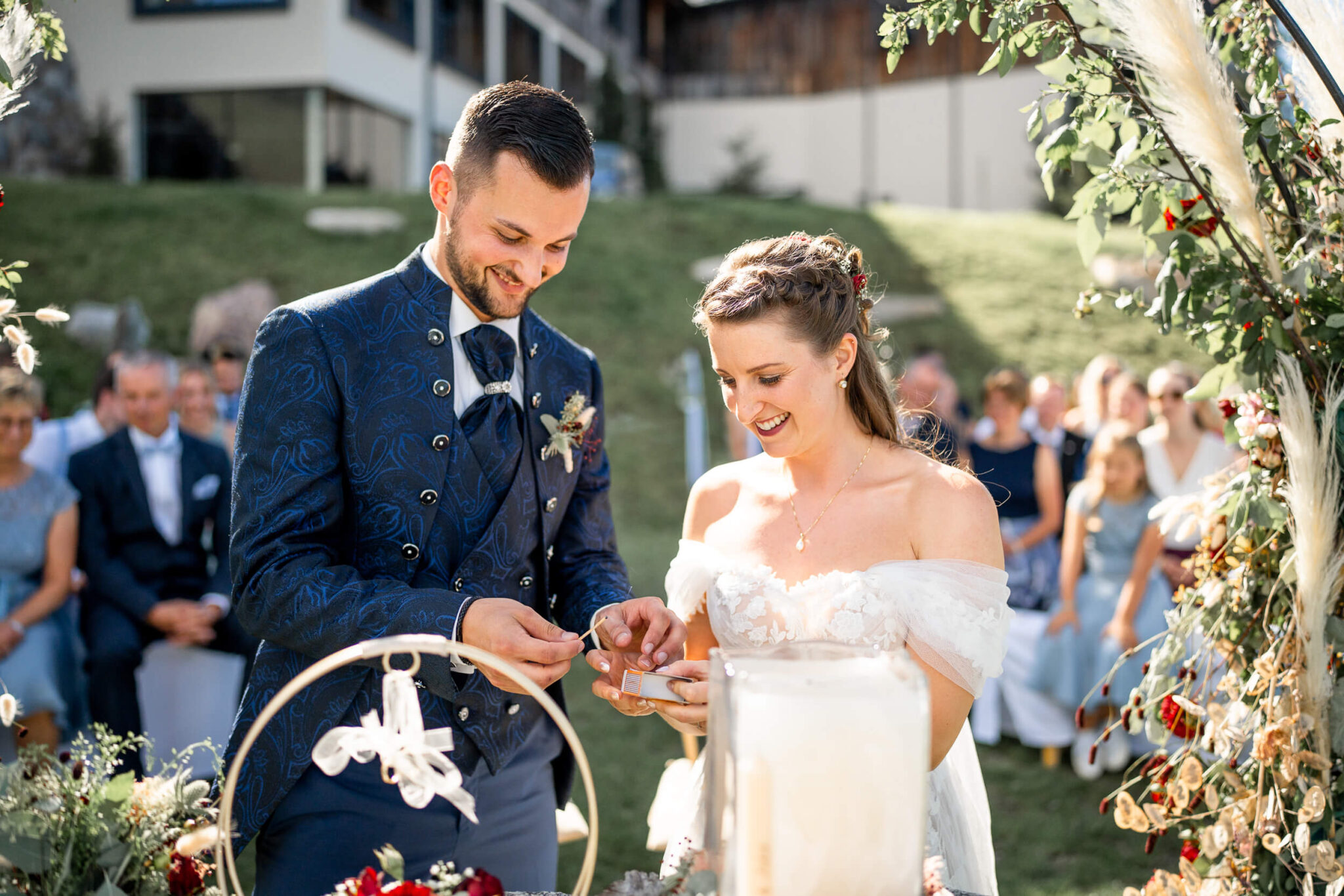 Wedding couple lighting their unity candle during the outdoor ceremony