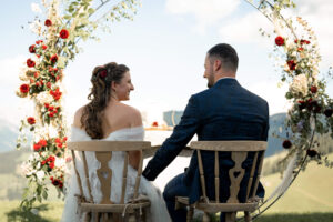 Close-up of the wedding couple looking at each other and laughing during the ceremony