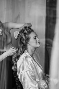 Black and white side view of the bride during styling