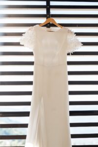 The wedding dress hanging from a metal frame