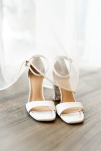 Close-up of the bride's shoes beneath a curtain