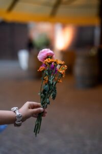 Close-up of a hand holding part of the floral table decoration