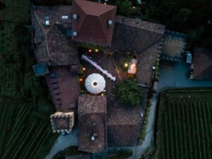 Drone photo of Castle Rametz courtyard at dusk with fairy lights and romantic lighting