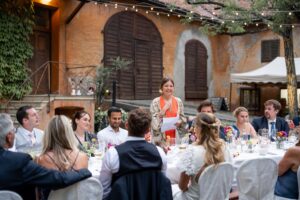 Maid of honor delivering an emotional speech at the wedding dinner table