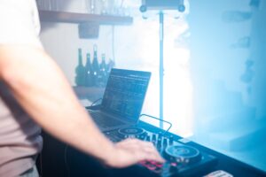 Medium close-up of the DJ booth and laptop during the wedding reception