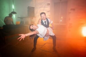 Groom holding his bride in their signature pose on the dance floor