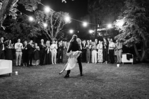 Groom holding his bride in an elegant dance pose while spinning her
