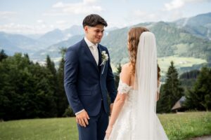 Groom looking lovingly at his bride during the first look