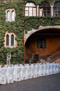 White reception table prepared for dinner in the castle courtyard