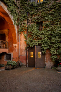 Golden evening light in the castle courtyard with ivy-covered walls