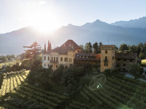 Drone view of Schloss Rametz with the setting sun above the mountains