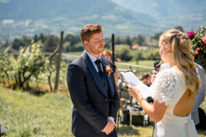 The groom's emotional reaction as the bride reads her vows