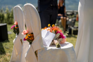 Close-up of the ceremony chairs decorated with flowers and wedding vows