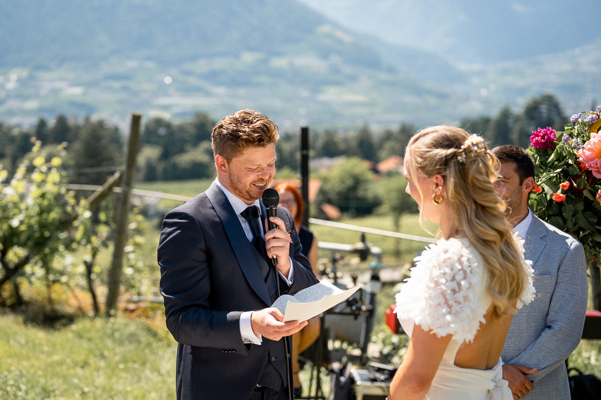 Groom reading his wedding vows to his bride during the ceremony