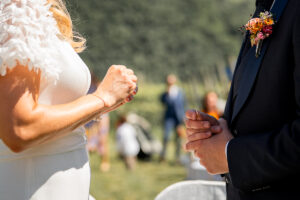 Close-up of the couple's hands holding the wedding rings