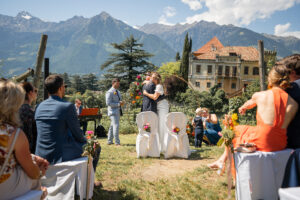 Intimate embrace of the wedding couple after the kiss with the mountain scenery behind them