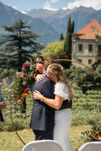 Medium close-up of the bride holding her groom in a tight embrace