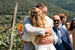 Tight embrace between the bride and an emotional guest