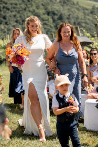 The bride approaches the groom together with her son and mother