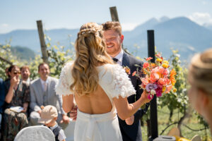 Bride and groom meet, and the groom smiles lovingly at his bride