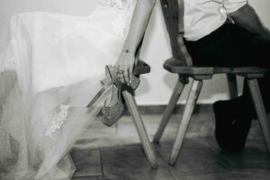 Detail photo of the bride’s hand holding her wedding shoe