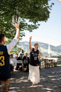 Bride throwing a tennis ball during a wedding game