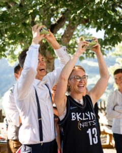 Wedding couple happily holding up their prize after a wedding challenge