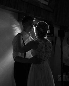 Black-and-white photo of the wedding dance in spotlight lighting