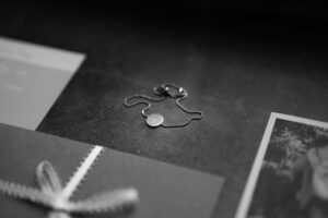 Close-up flatlay of jewelry and a photo bracelet