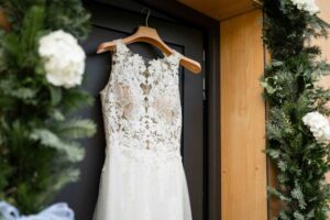 Close-up of the wedding dress hanging in the doorway