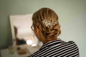 Detail photo of the bride’s updo with silver hair accessories