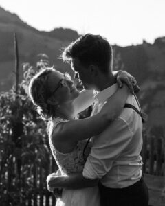 High-contrast black-and-white photo of an intimate embrace just before a kiss