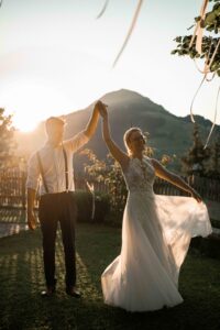 Bride being twirled by her groom at sunset