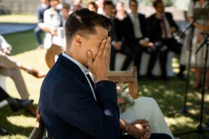 Side-view photo of the emotional groom during the ceremony