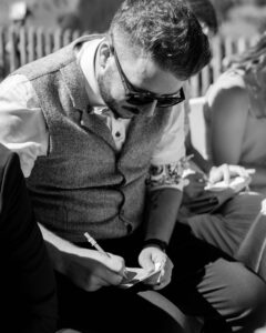 High-contrast black-and-white photo of a guest writing a wish