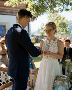 Ring exchange during the ceremony with focus on the smiling bride