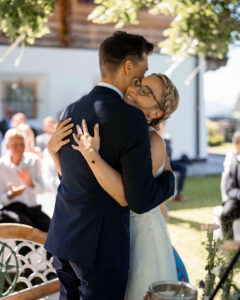 Wedding couple embracing and laughing after the ring exchange