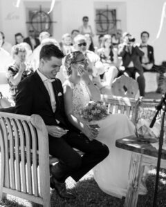 Black-and-white photo of the bride wiping away tears